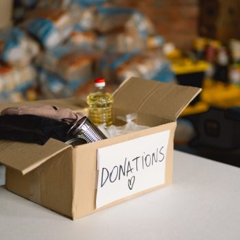Donation food and cloting for refugees, support of war victims, helping people, charity. Humanitarian aid concept.