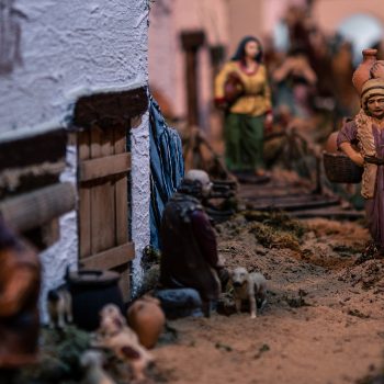 Typical decorative figures of traditional in Christmas of the portal of Belen. A close up photo of a beautiful landscape nativity scene of Spain with figure of people at street