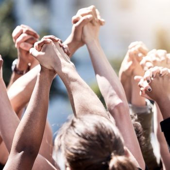 Uniting for a cause. Shot of a group of protestors with their fists raised