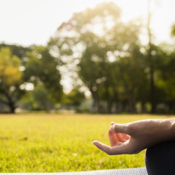 Young asian woman yoga outdoors keep calm and meditates while practicing yoga to explore the inner peace. Yoga and meditation have good benefits for health. Yoga Sport and Healthy lifestyle concept.